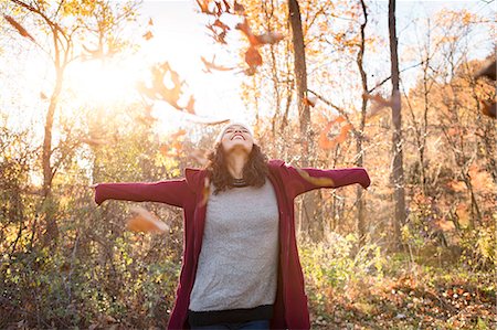 simsearch:649-08824082,k - Young woman throwing autumn leaves in forest Stock Photo - Premium Royalty-Free, Code: 614-08884463