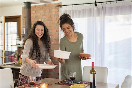 simsearch:649-08824511,k - Two young women friends preparing meal at kitchen table Stock Photo - Premium Royalty-Free, Code: 614-08884483