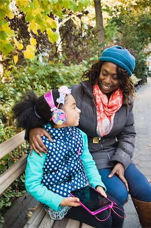 family and us and city - Mother and daughter in park sitting on bench Stock Photo - Premium Royalty-Free, Code: 614-08884509