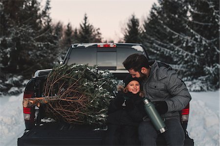 Father and daughter on back of pick up truck with their Christmas tree Stock Photo - Premium Royalty-Free, Code: 614-08884574