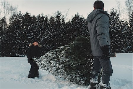 family carrying christmas tree - Father and daughter out getting their own Christmas tree Stock Photo - Premium Royalty-Free, Code: 614-08884571