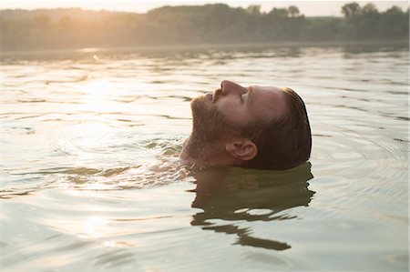 submerging - Man relaxing, floating in river Stock Photo - Premium Royalty-Free, Code: 614-08884665