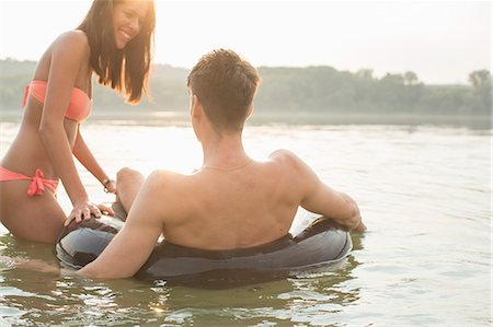 simsearch:614-09017276,k - Friends having fun with inflatable ring in river Photographie de stock - Premium Libres de Droits, Code: 614-08884660