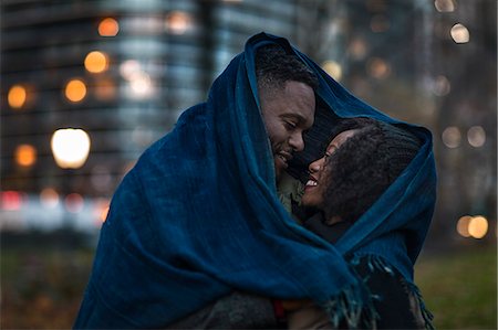 simsearch:614-06402761,k - Romantic couple wrapped in blanket in city at night Stock Photo - Premium Royalty-Free, Code: 614-08884738