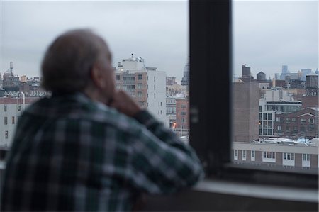 simsearch:614-00653657,k - Man looking out of window, Manhattan, New York, USA Stock Photo - Premium Royalty-Free, Code: 614-08884788