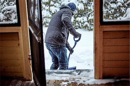 sacar fotos - Man shovelling snow from pathway, rear view Photographie de stock - Premium Libres de Droits, Code: 614-08884833