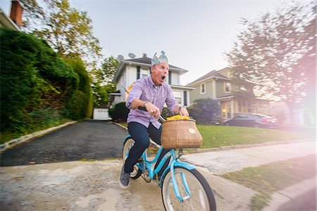 riding a bike funny pic - Man uncertain on vintage bicycle Stock Photo - Premium Royalty-Free, Code: 614-08884880