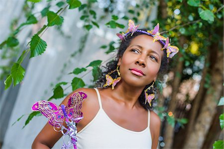 Portrait of mature woman wearing butterflies in her hair Stock Photo - Premium Royalty-Free, Code: 614-08884907