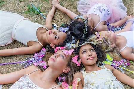 simsearch:614-08884464,k - Group of young girls dressed as fairies, lying in circle, heads together Stockbilder - Premium RF Lizenzfrei, Bildnummer: 614-08884910