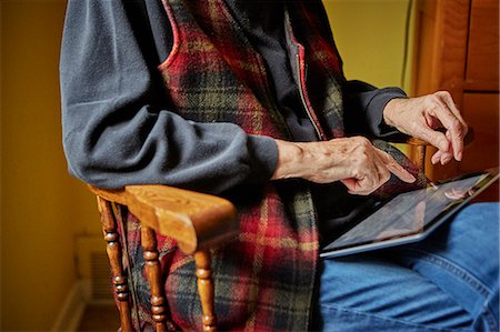 simsearch:614-08884946,k - Senior woman sitting in chair, using digital tablet, mid section Stock Photo - Premium Royalty-Free, Code: 614-08884952