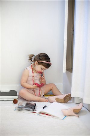 shoe on wall - Girl dressing up, playing with lipstick Stock Photo - Premium Royalty-Free, Code: 614-08884980