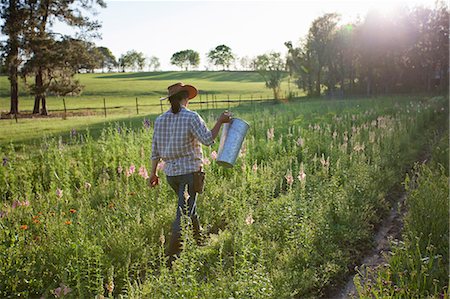 rural business owner - Young woman carrying bucket in snapdragons (antirrhinum)  flower farm field Stock Photo - Premium Royalty-Free, Code: 614-08885043