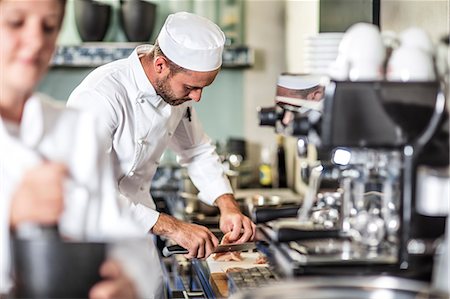 Chef preparing food in kitchen Stock Photo - Premium Royalty-Free, Code: 614-08885094