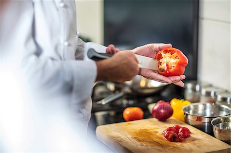 simsearch:614-08885076,k - Chef de-seeding red pepper with knife Stock Photo - Premium Royalty-Free, Code: 614-08885090