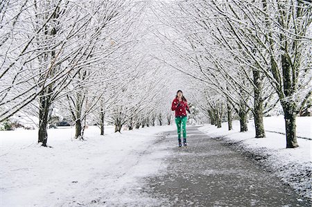 Woman jogging along pathway, in snow covered rural setting Stock Photo - Premium Royalty-Free, Code: 614-08885103