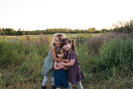 simsearch:614-06043912,k - Portrait of three young girls standing together in field, hugging Stock Photo - Premium Royalty-Free, Code: 614-08880764