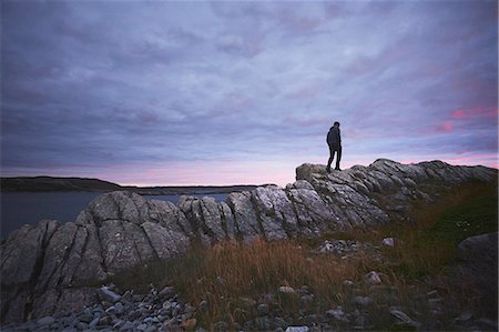 simsearch:614-08880777,k - Hiker hiking on rocks at dusk, Fogo Island, Newfoundland, Canada Stock Photo - Premium Royalty-Free, Code: 614-08880777