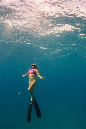 swim woman - Underwater view of woman snorkelling, Oahu, Hawaii, USA Stock Photo - Premium Royalty-Free, Code: 614-08880843