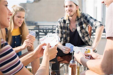 simsearch:614-08881018,k - Young adults playing card game at roof terrace party, Budapest, Hungary Fotografie stock - Premium Royalty-Free, Codice: 614-08881039