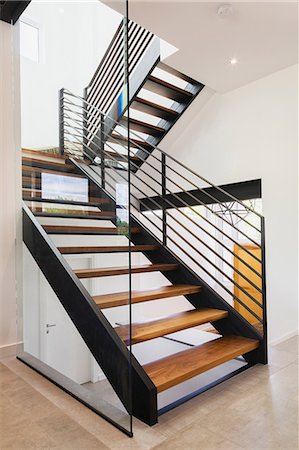 American walnut wood and black powder coated cold rolled steel stairs inside a modern cube style home, Quebec, Canada Stock Photo - Premium Royalty-Free, Code: 614-08881120