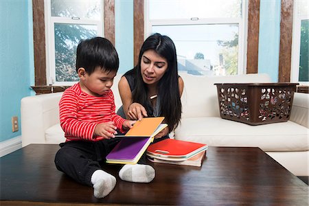 simsearch:614-07911891,k - Male toddler sitting on coffee table reading storybook with mother Stock Photo - Premium Royalty-Free, Code: 614-08881162