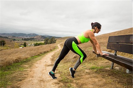 simsearch:649-09111401,k - Mid adult woman training, stretching whilst leaning forward on bench in landscape Foto de stock - Sin royalties Premium, Código: 614-08881192