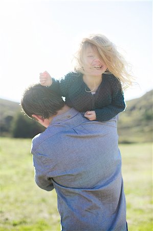 simsearch:614-03080479,k - Portrait of girl being carried over father's shoulder in field Stock Photo - Premium Royalty-Free, Code: 614-08881205