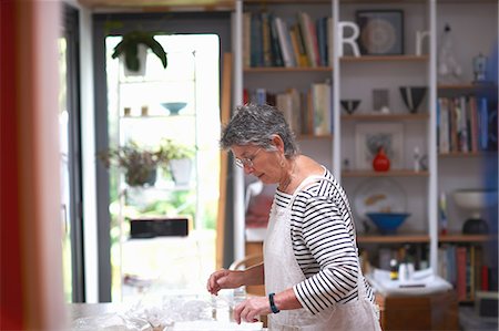 simsearch:614-08881367,k - Senior woman in kitchen, arranging clear pots on work surface Photographie de stock - Premium Libres de Droits, Code: 614-08881364