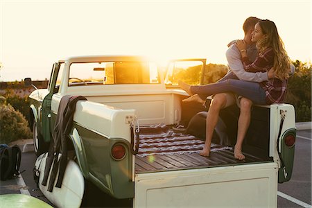 romantic road - Surfing couple in back of pickup truck at Newport Beach, California, USA Stock Photo - Premium Royalty-Free, Code: 614-08881446