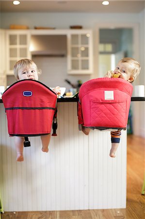 simsearch:614-07735453,k - Rear view portrait of male and female toddlers looking back from kitchen counter Stock Photo - Premium Royalty-Free, Code: 614-08908414