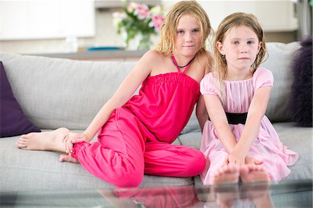 simsearch:649-08950750,k - Portrait of two young sisters sitting on sofa Stock Photo - Premium Royalty-Free, Code: 614-08908486