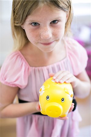 simsearch:640-05760828,k - Portrait of girl holding piggy bank Stock Photo - Premium Royalty-Free, Code: 614-08908490
