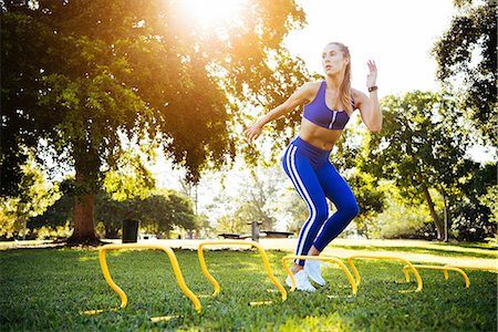 simsearch:649-07710130,k - Young woman training between agility hurdles in park Foto de stock - Sin royalties Premium, Código: 614-08908540