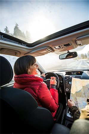 Woman driving car, friend in passenger seat looking at map Stock Photo - Premium Royalty-Free, Code: 614-08908588