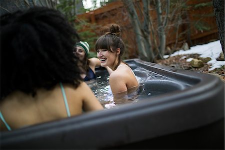 pictures of people in snow in bathing suit - Three friends relaxing in hot tub Stock Photo - Premium Royalty-Free, Code: 614-08908597