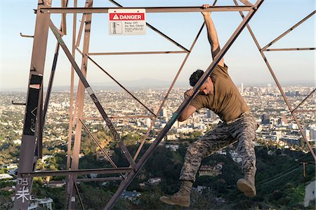 simsearch:614-06169134,k - Soldier wearing combat clothing dangling from electricity pylon, Runyon Canyon, Los Angeles, California, USA Stock Photo - Premium Royalty-Free, Code: 614-08926244