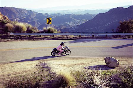 Man wearing pyjamas riding motorcycle, Malibu Canyon, California, USA Stock Photo - Premium Royalty-Free, Code: 614-08926283