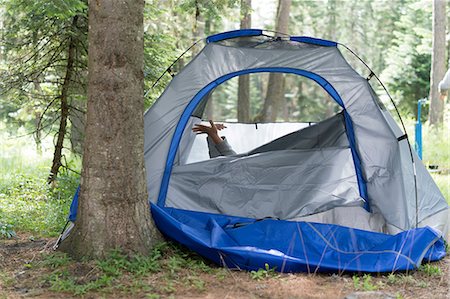 Teenage boy's hands poking out of tent, Washington, USA Stock Photo - Premium Royalty-Free, Code: 614-08926384