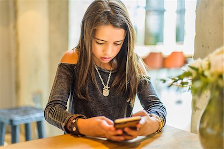 digital native - Girl texting on smartphone Stock Photo - Premium Royalty-Free, Code: 614-08926393