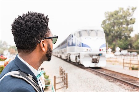 simsearch:614-08926442,k - Young businessman watching train arrive at platform Stock Photo - Premium Royalty-Free, Code: 614-08926445