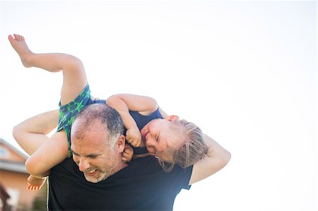 Father and son fooling around, outdoors, father carrying son over shoulders Stock Photo - Premium Royalty-Free, Code: 614-08926586
