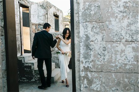 Bride and groom outdoors, holding hands, smiling Stock Photo - Premium Royalty-Free, Code: 614-08926607