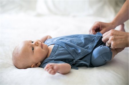 Mother dressing baby boy, close-up Stock Photo - Premium Royalty-Free, Code: 614-08946140