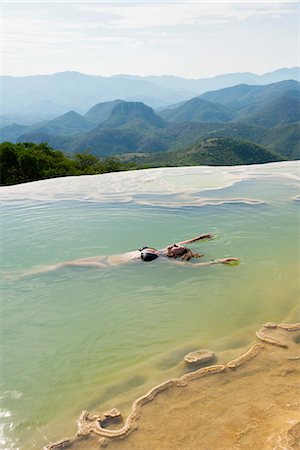 Woman floating in thermal spring, Hierve el Agua, Oaxaca, Mexico. Stock Photo - Premium Royalty-Free, Code: 614-08946167