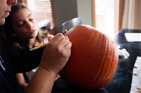 Father and daughter pumpkin carving Stock Photo - Premium Royalty-Free, Code: 614-08946333