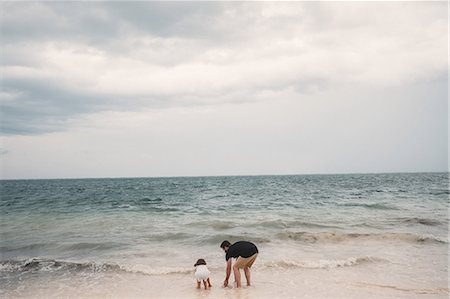 Father and daughter playing on beach, Cancun, Mexico Stock Photo - Premium Royalty-Free, Code: 614-08946368