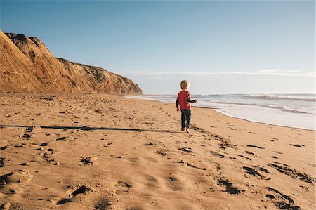 simsearch:614-08487786,k - Young boy standing on beach, looking at sea, rear view, Buellton, California, USA Stock Photo - Premium Royalty-Free, Code: 614-08946439