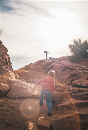 simsearch:614-08487786,k - Young boy climbing rock in desert, rear view, Moab, Utah, USA Stock Photo - Premium Royalty-Free, Code: 614-08946445