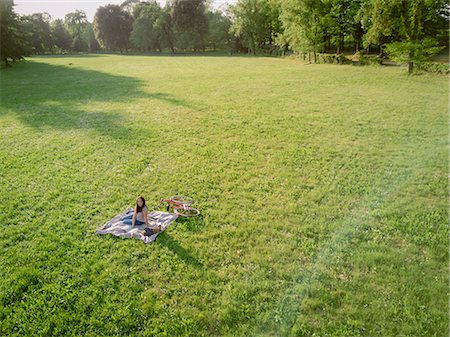 sitting aerial view - Woman relaxing on grass Stock Photo - Premium Royalty-Free, Code: 614-08946492