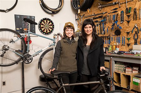 dart board photography - Female employees in bicycle workshop Stock Photo - Premium Royalty-Free, Code: 614-08946574